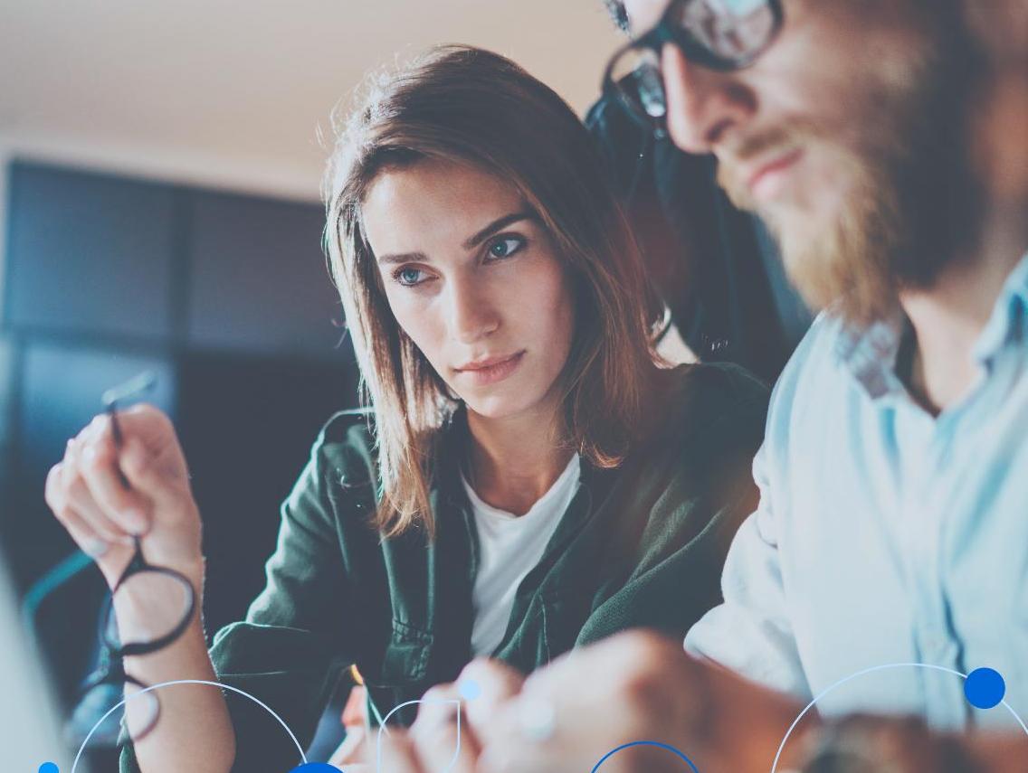 Man and woman looking at data on laptop